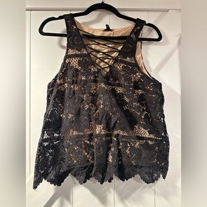 Lacey black tank top. Cross tie in front. Tags attached. Never worn